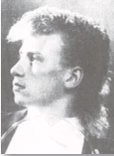 Black and white portrait of a person with a mullet hairstyle, looking to the side.